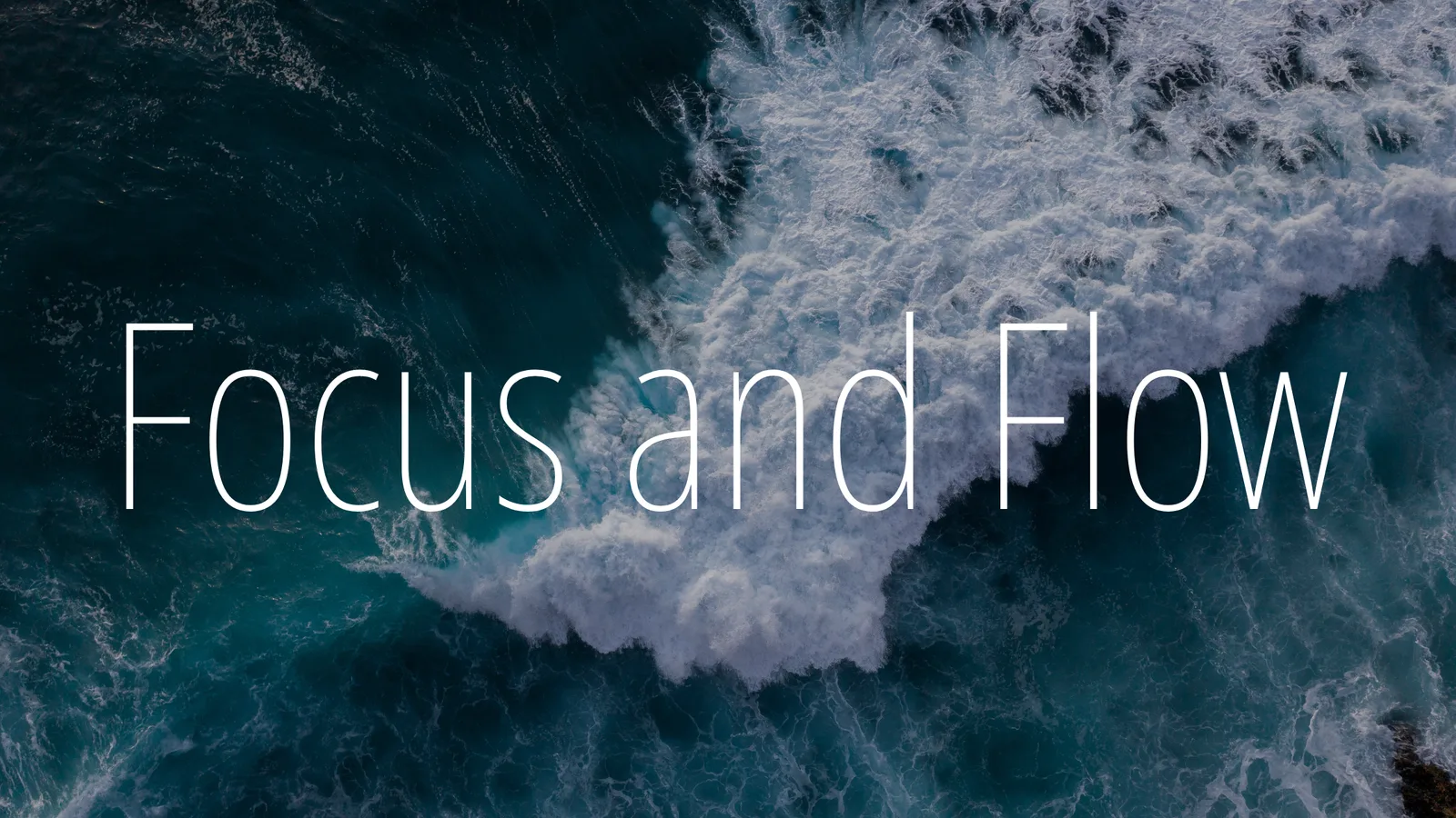 Crashing ocean wave with the words Focus and Flow