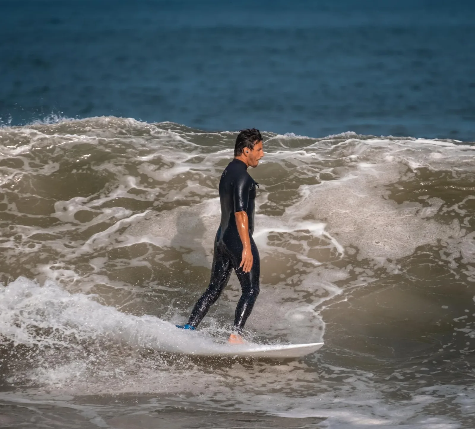 Mike Forgie surfing a small wave